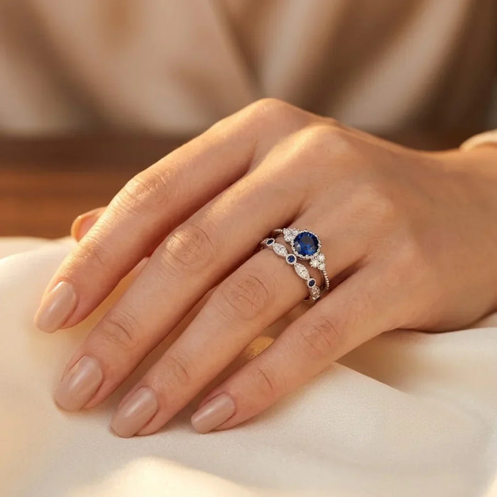 Silberring mit blauem Saphir-Halo, elegantes Design von Rose & Oliver, der den Ring mit leuchtendem zentralen Stein-Detail zeigt.